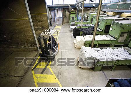 Carpet tile factory, forklift preparing fluffy fibers for processing View Large Photo Image Picture - Carpet tile factory, forklift preparing fluffy fibers for processing. Fotosearch