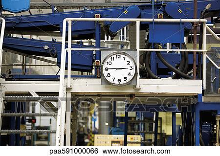 Clock mounted beside metal stairs in carpet tile factory View Large Photo Image Stock Photograph - Clock mounted beside metal stairs in carpet tile factory. Fotosearch