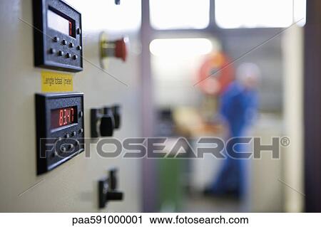 Stock Image - Close-up of control panel on weaving machine in carpet tile factory. Fotosearch