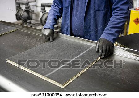 Factory worker checking quality of carpet tile View Large Photo Image Picture - Factory worker checking quality of carpet tile. Fotosearch