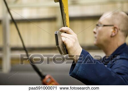 Factory worker operating lift in carpet tile factory View Large Photo Image Stock Image - Factory worker operating lift in carpet tile factory. Fotosearch