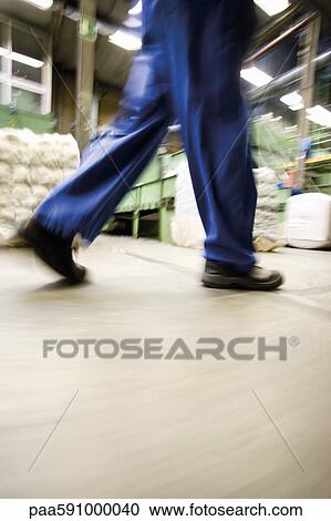 Factory worker walking, low section View Large Photo Image Stock Image - Factory worker walking, low section. Fotosearch