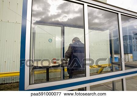 Man in outdoor smoking area View Large Photo Image Stock Photo - Man in outdoor smoking area. Fotosearch