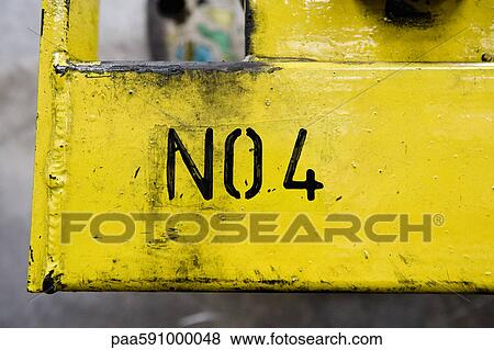 No 4 stenciled on yellow metal surface in factory View Large Photo Image Stock Photo - No 4 stenciled on yellow metal surface in factory. Fotosearch