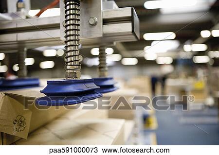 Pneumatic handling robot with technical springs and suction cups designed to lift cardboard boxes in warehouse View Large Photo Image Stock Image - Pneumatic handling robot with technical springs and suction cups designed to lift cardboard boxes in warehouse. Fotosearch