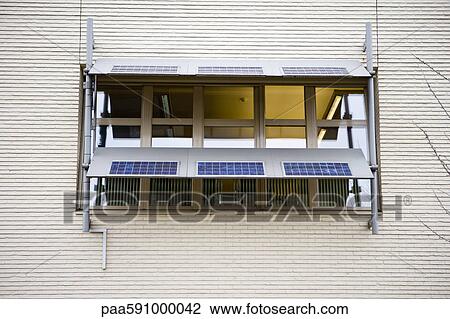 Solar panels mounted in front of window on building exterior View Large Photo Image Stock Image - Solar panels mounted in front of window on building exterior. Fotosearch