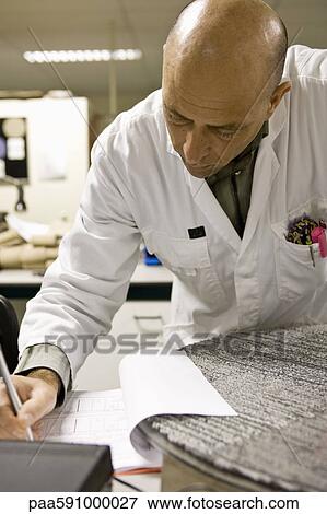 Technician conducting test in lab at carpet tile factory View Large Photo Image Stock Photo - Technician conducting test in lab at carpet tile factory. Fotosearch