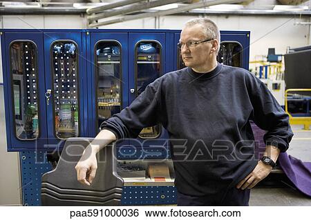 Textile worker taking a break View Large Photo Image Stock Photograph - Textile worker taking a break. Fotosearch