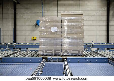 Wrapped pallet of cardboard boxes on conveyor belt in carpet tile factory View Large Photo Image Stock Photo - Wrapped pallet of cardboard boxes on conveyor belt in carpet tile factory. Fotosearch