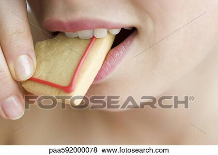 Stock Photo - Biting into cookie. Fotosearch