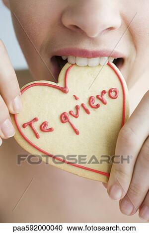 Eating heart-shaped cookie View Large Photo Image Stock Image - Eating heart-shaped cookie. Fotosearch
