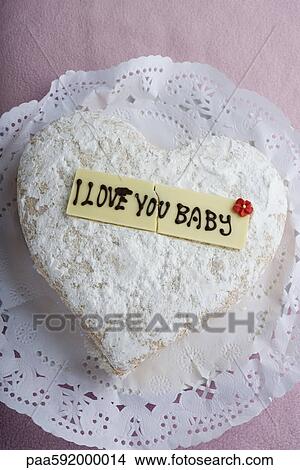 Picture - Heart-shaped pastry with lettering on decorative white chocolate reading, "I love you baby". Fotosearch