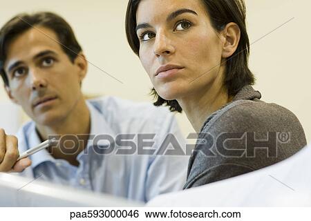 Business people looking up attentively, portrait View Large Photo Image Stock Photograph - Business people looking up attentively, portrait. Fotosearch