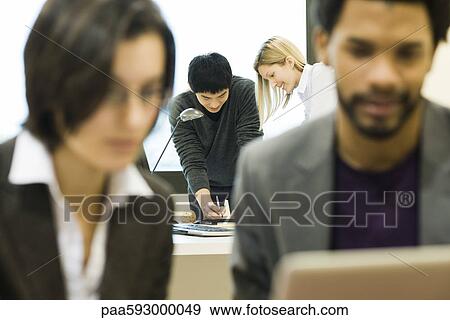 Colleagues working together on project View Large Photo Image Stock Photo - Colleagues working together on project. Fotosearch