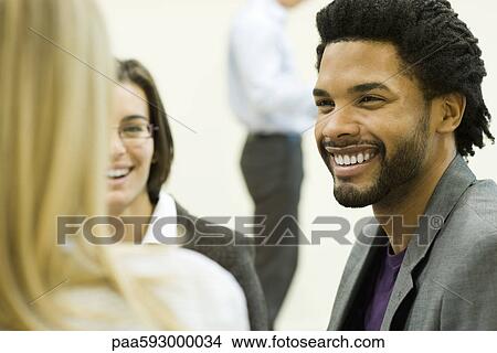 Executive laughing with colleagues View Large Photo Image Picture - Executive laughing with colleagues. Fotosearch