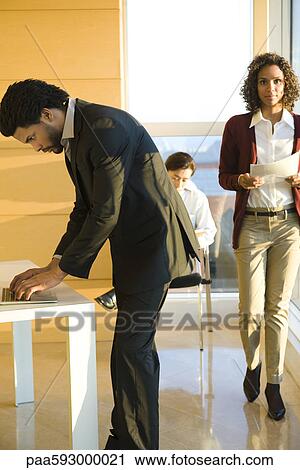 Stock Image - Executives busy at work. Fotosearch