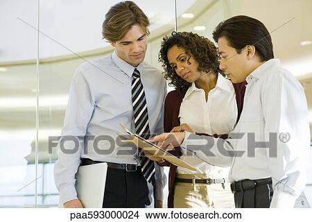 Executives discussing document View Large Photo Image Picture - Executives discussing document. Fotosearch