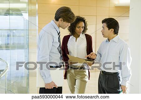 Executives discussing document View Large Photo Image Picture - Executives discussing document. Fotosearch
