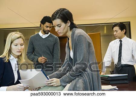 Executives discussing document View Large Photo Image Stock Image - Executives discussing document. Fotosearch