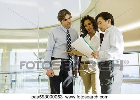 Executives discussing document View Large Photo Image Stock Image - Executives discussing document. Fotosearch