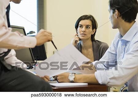 Executives discussing document View Large Photo Image Stock Photo - Executives discussing document. Fotosearch