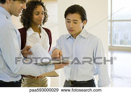 Stock Photo - Executives discussing document. Fotosearch