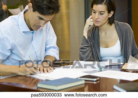 Executives doing paperwork together View Large Photo Image Stock Image - Executives doing paperwork together. Fotosearch