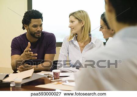 Executives listening to colleague in meeting View Large Photo Image Stock Photo - Executives listening to colleague in meeting. Fotosearch