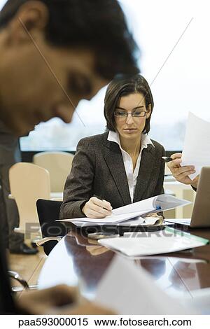 Executives reviewing documents in meeting View Large Photo Image Stock Photography - Executives reviewing documents in meeting. Fotosearch