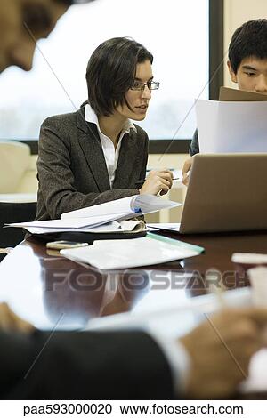 Executives working together at conference table View Large Photo Image Stock Image - Executives working together at conference table. Fotosearch