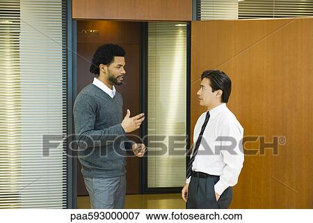 Male executives chatting in doorway View Large Photo Image Stock Photo - Male executives chatting in doorway. Fotosearch