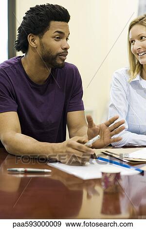 Man explaining idea to colleague in meeting View Large Photo Image Stock Photo - Man explaining idea to colleague in meeting. Fotosearch