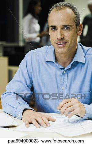 Businessman working in office at night, portrait View Large Photo Image Stock Image - Businessman working in office at night, portrait. Fotosearch