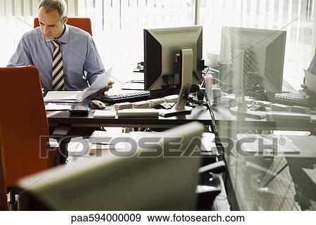 Businessman working in office View Large Photo Image Stock Photo - Businessman working in office. Fotosearch