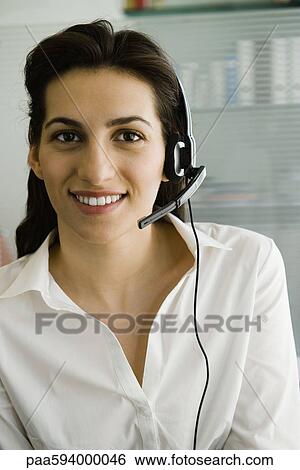 Stock Photograph - Businesswoman wearing telephone headset, portrait. Fotosearch