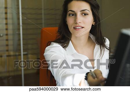 Businesswoman working in office, portrait View Large Photo Image Stock Photo - Businesswoman working in office, portrait. Fotosearch
