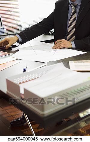 Executive working in office, cropped View Large Photo Image Stock Photography - Executive working in office, cropped. Fotosearch