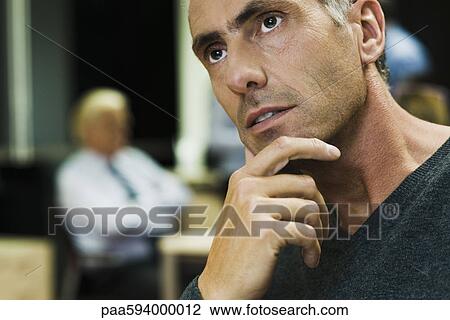 Man in thought with hand under chin, portrait View Large Photo Image Stock Image - Man in thought with hand under chin, portrait. Fotosearch