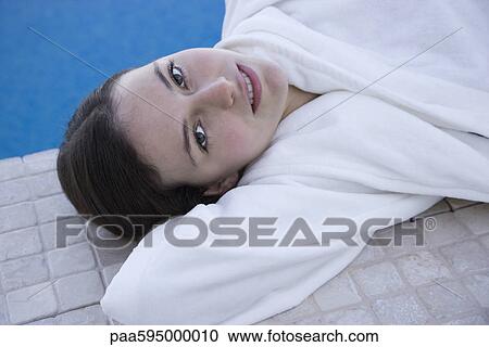 Woman relaxing beside pool, portrait View Large Photo Image Stock Image - Woman relaxing beside pool, portrait. Fotosearch