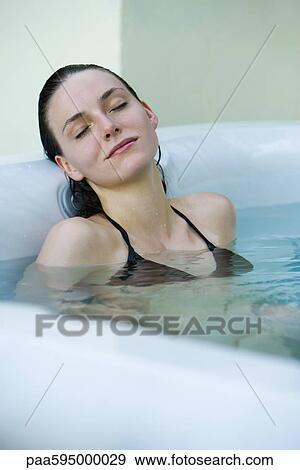 Stock Photo - Woman relaxing in bath. Fotosearch