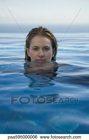 Stock Photograph - Woman relaxing in water, portrait. Fotosearch