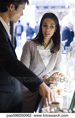 Colleagues chatting during coffee break View Large Photo Image Stock Image - Colleagues chatting during coffee break. Fotosearch
