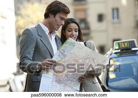 Couple consulting map outdoors View Large Photo Image Stock Photo - Couple consulting map outdoors. Fotosearch