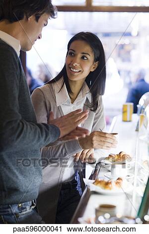 Couple enjoying coffee in cafe View Large Photo Image Stock Image - Couple enjoying coffee in cafe. Fotosearch