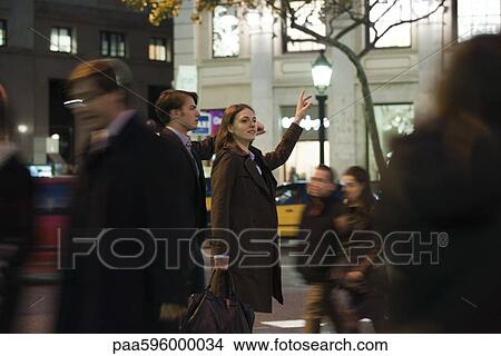 Couple hailing taxi at night View Large Photo Image Picture - Couple hailing taxi at night. Fotosearch