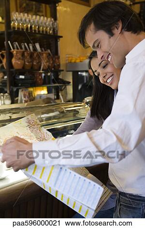 Stock Image - Couple looking at map. Fotosearch