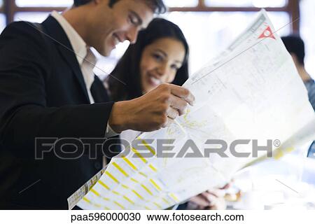 Couple looking at map together View Large Photo Image Stock Image - Couple looking at map together. Fotosearch