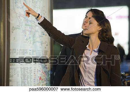 Stock Photo - Couple looking at subway map. Fotosearch
