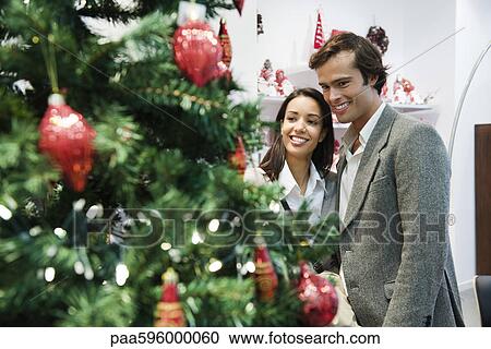 Stock Image - Couple shopping for Christmas decorations. Fotosearch