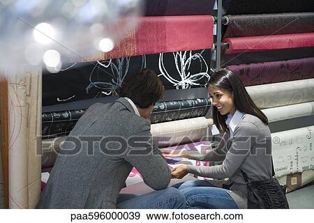 Stock Photo - Couple shopping for fabric. Fotosearch
